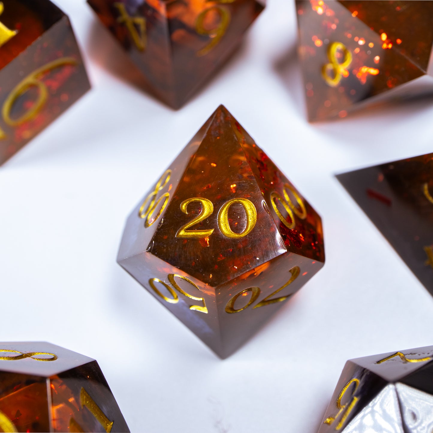 A close-up of a ten sided die at the heart of its kin, the rest of the dice set arranged in a circle around it.