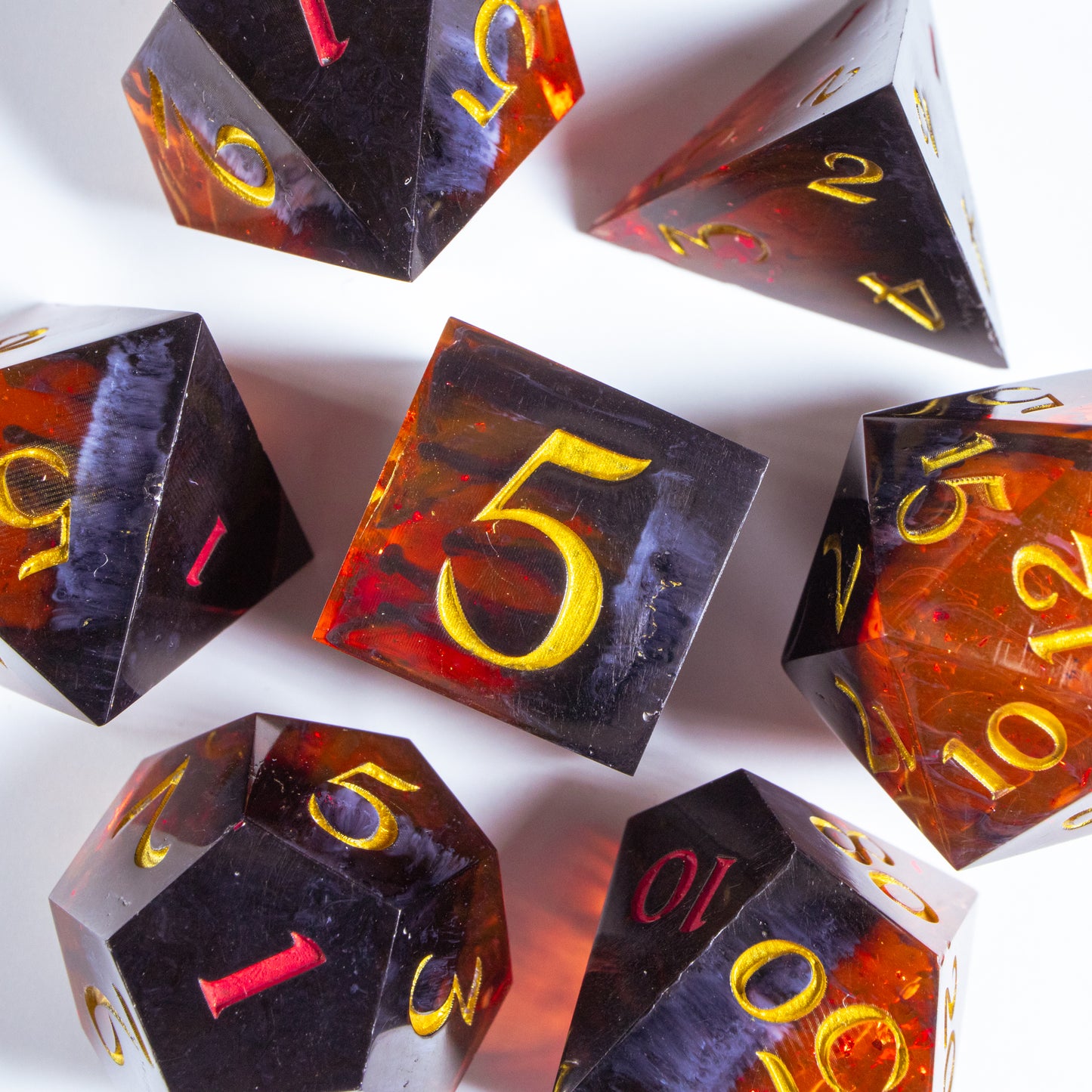 A bird’s-eye view of the complete set of seven polyhedral dice, encircling a six-sided die in the center.