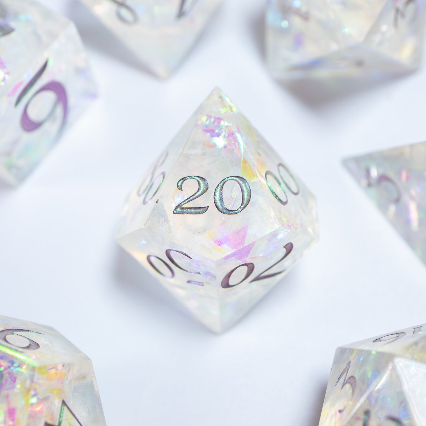 A close-up of a ten sided die at the heart of its kin, the rest of the dice set arranged in a circle around it.