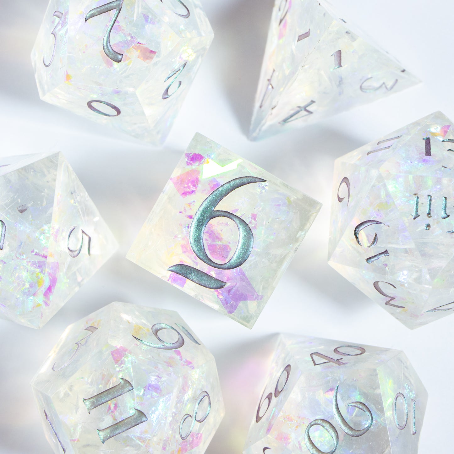 A bird’s-eye view of the complete set of seven polyhedral dice, encircling a six-sided die in the center.