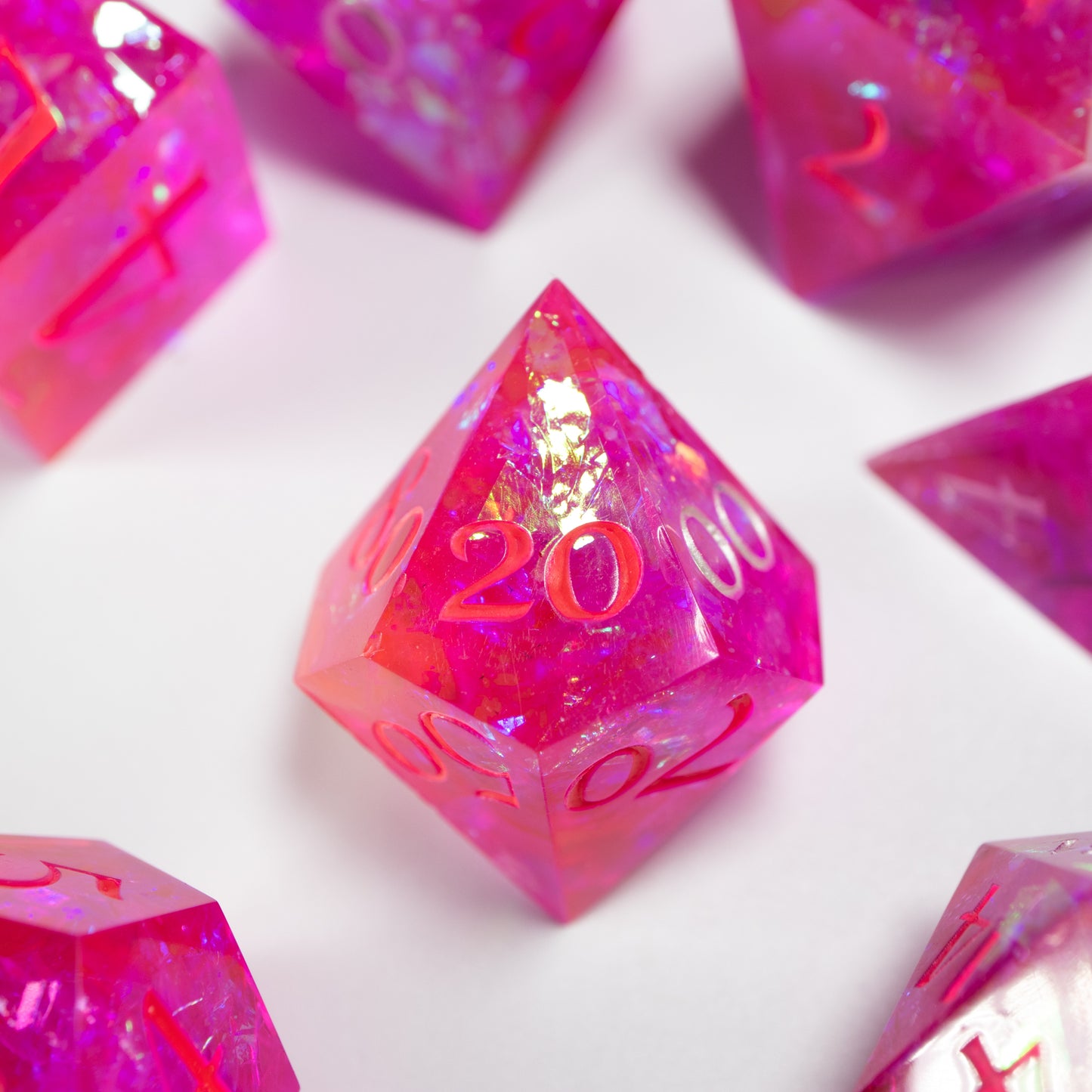 A close-up of a ten sided die at the heart of its kin, the rest of the dice set arranged in a circle around it.