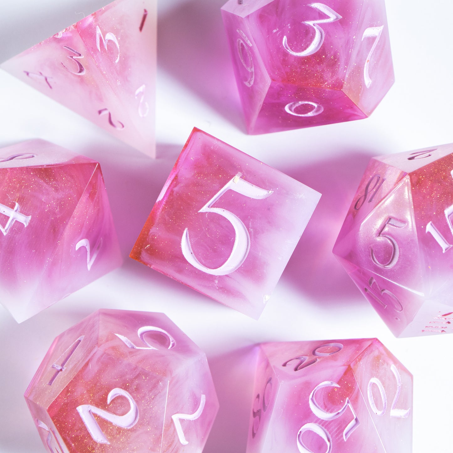 A bird’s-eye view of the complete set of seven polyhedral dice, encircling a six-sided die in the center.