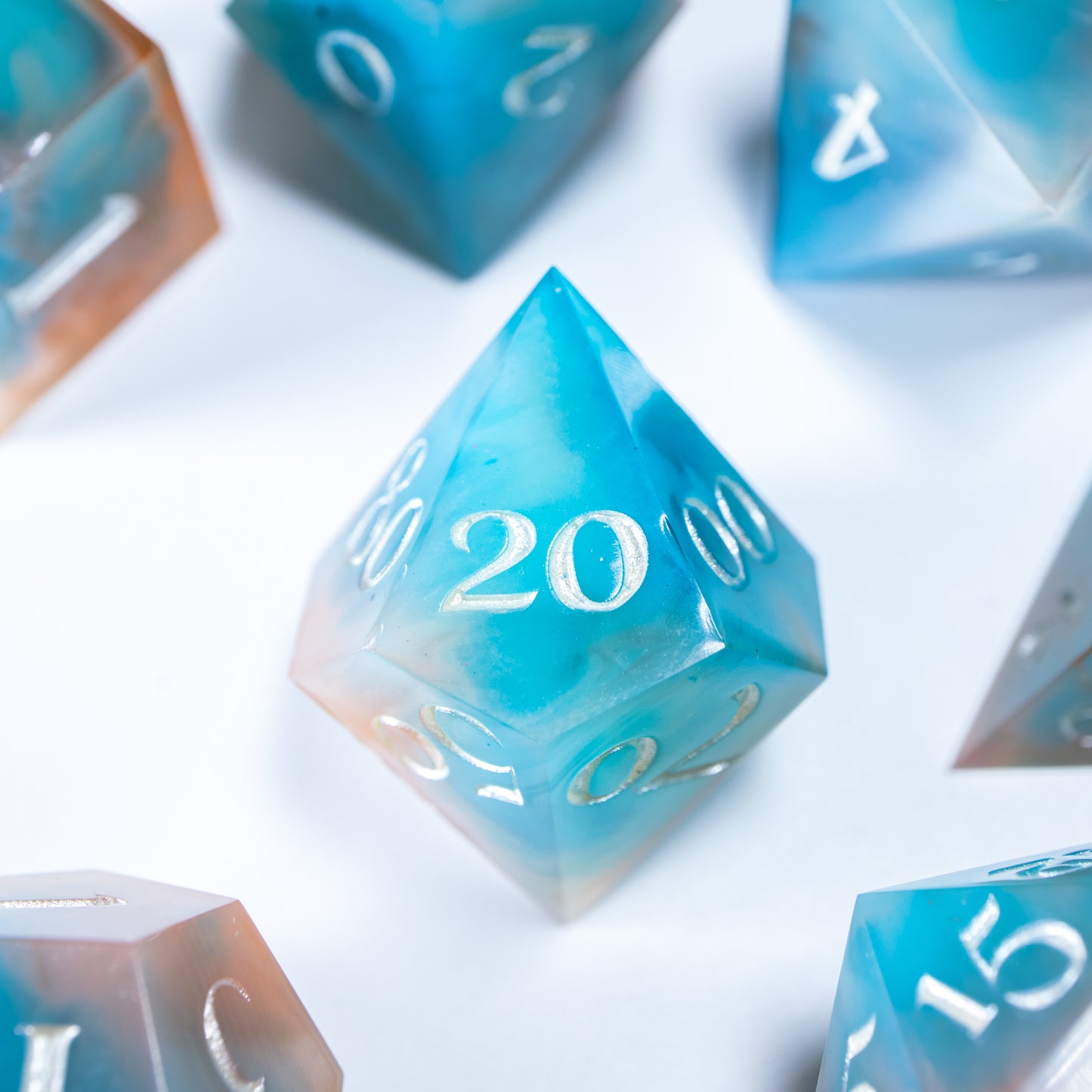 A close-up of a ten sided die at the heart of its kin, the rest of the dice set arranged in a circle around it.